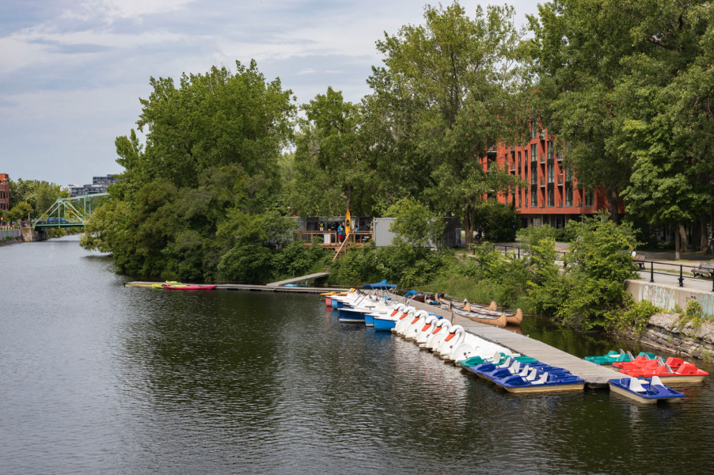 Colorful paddle boats and kayaks docked on the Lachine Canal near Griffintown